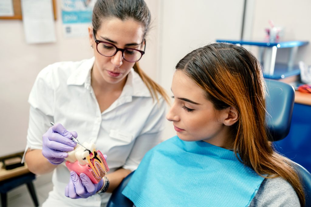 Dentist explaining what dental cavity looks